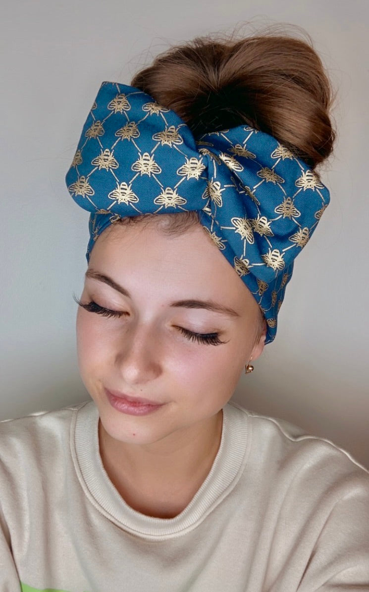 Blue wire headband with a golden bee pattern