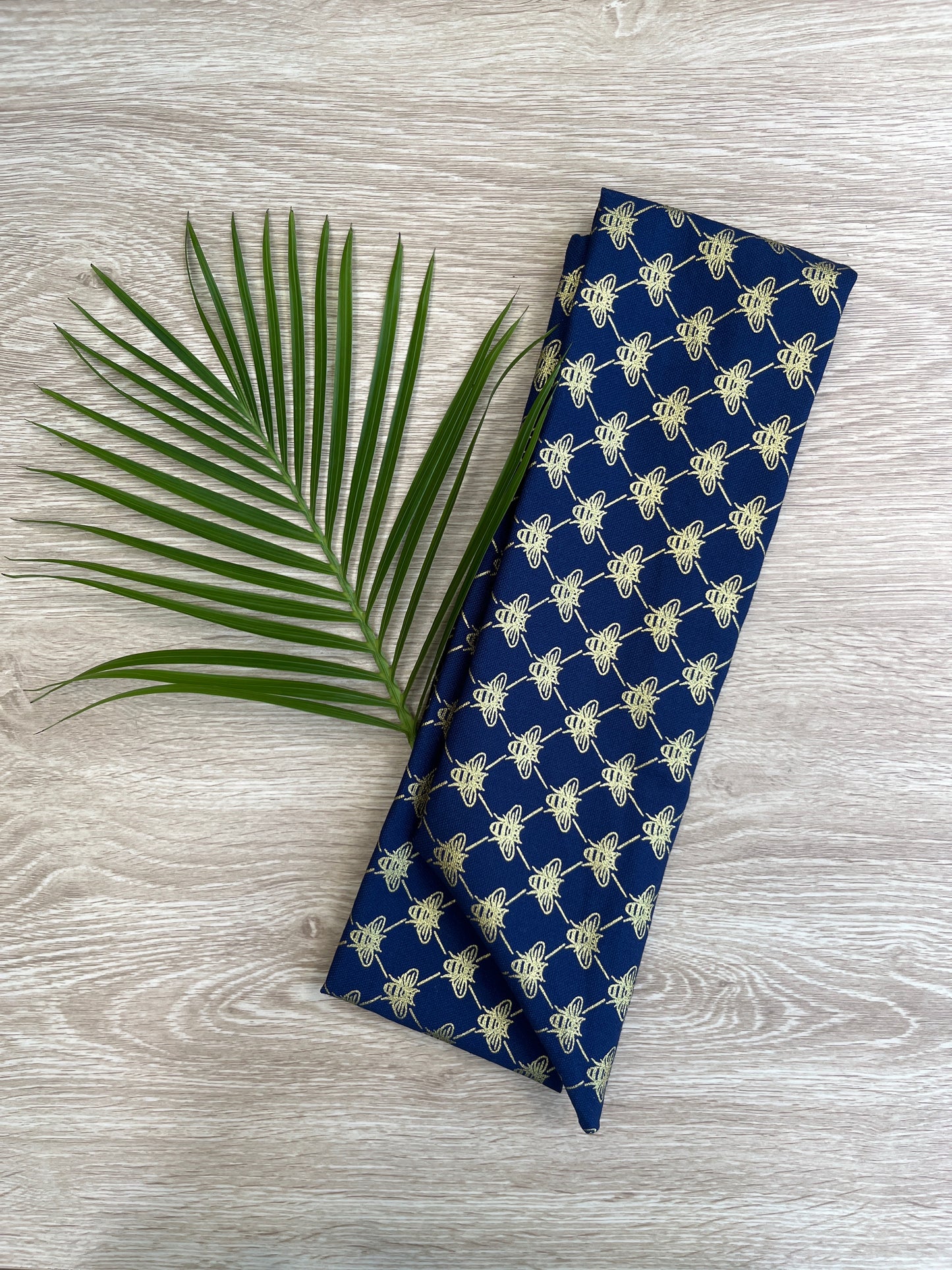 Blue wire headband with a golden bee pattern